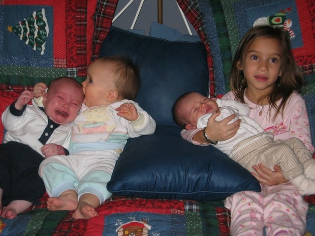 Caleb (still hungry), Zoe cuddling and kissing him to comfort him, Alexandra (5 1/2 yrs) holding Ava