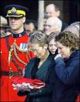 Margaret Galloway holds the flag that draped the coffin of her husband, RCMP Cpl. James Galloway, at his funeral service in Sher